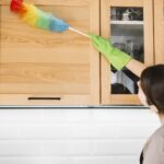 woman using colorful fluffy duster
