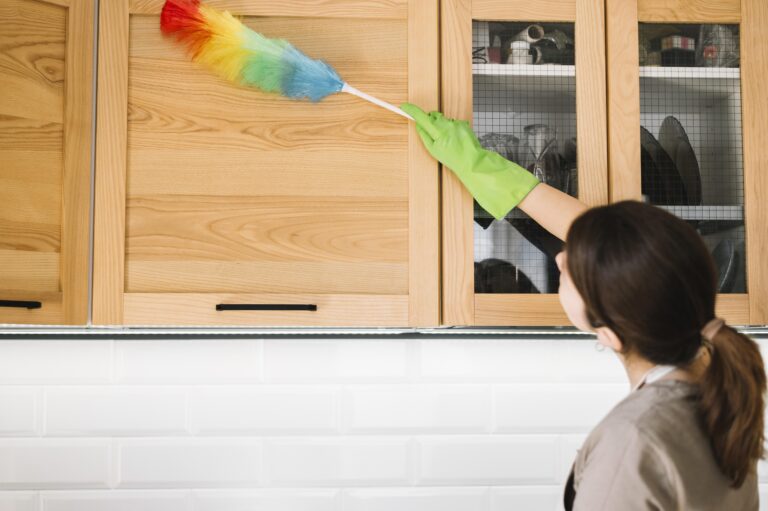 woman using colorful fluffy duster